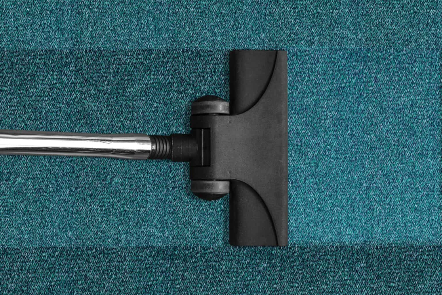 green carpet and vacuum cleaner