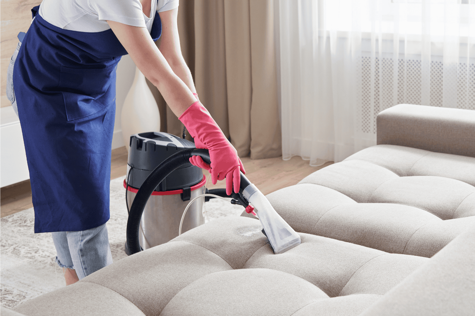 Woman vacuuming the sofa