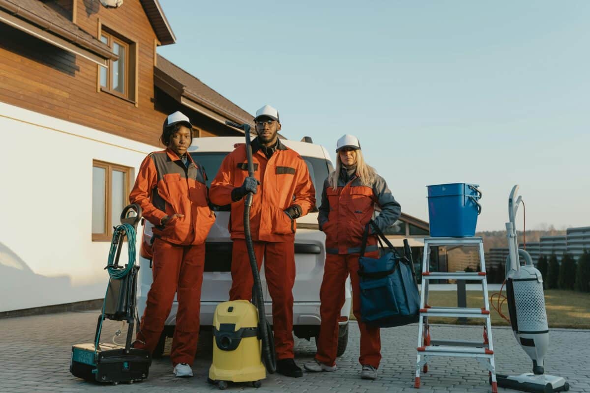3 people wearing cleaning clothes