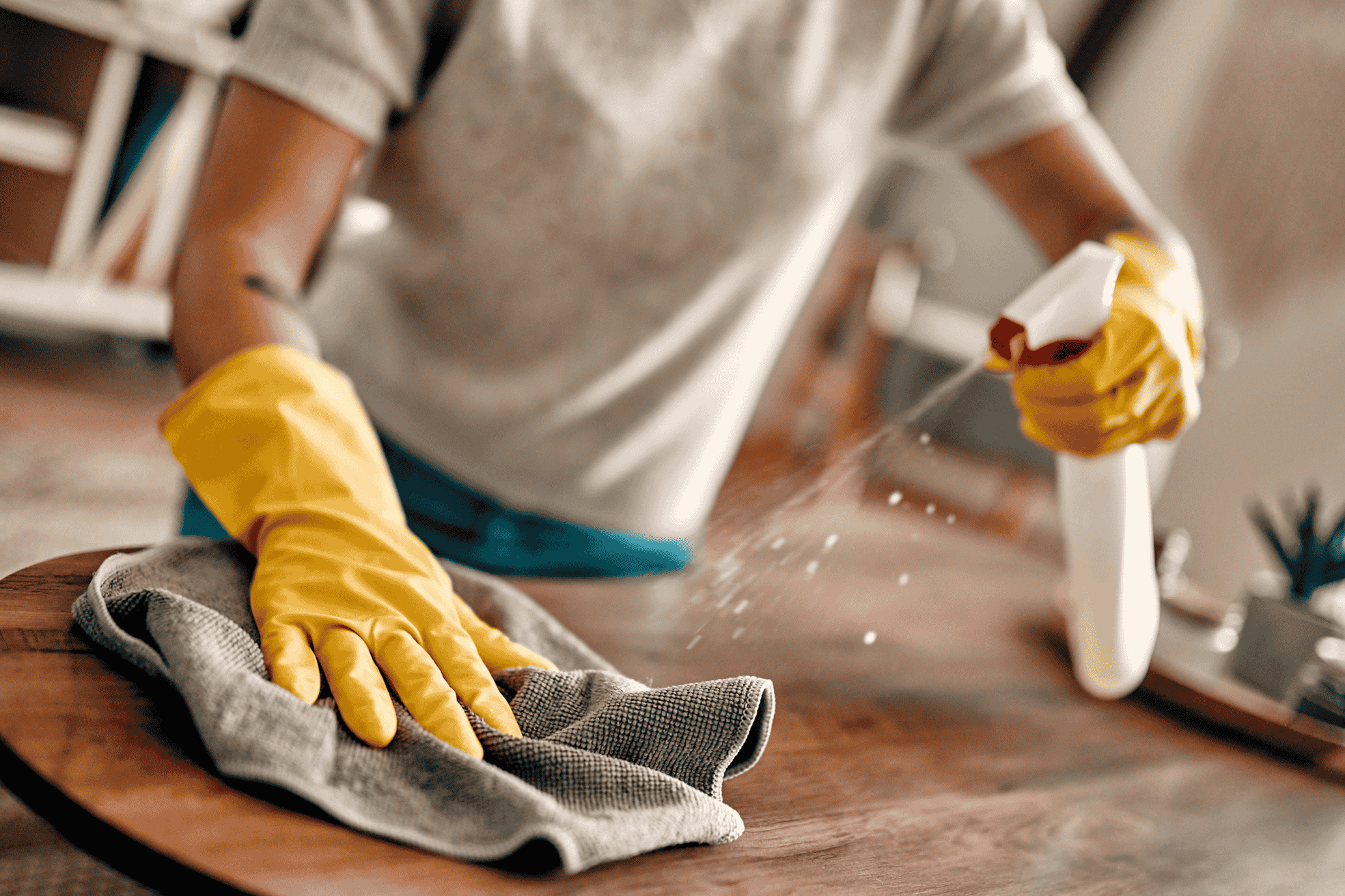 A person cleaning the table