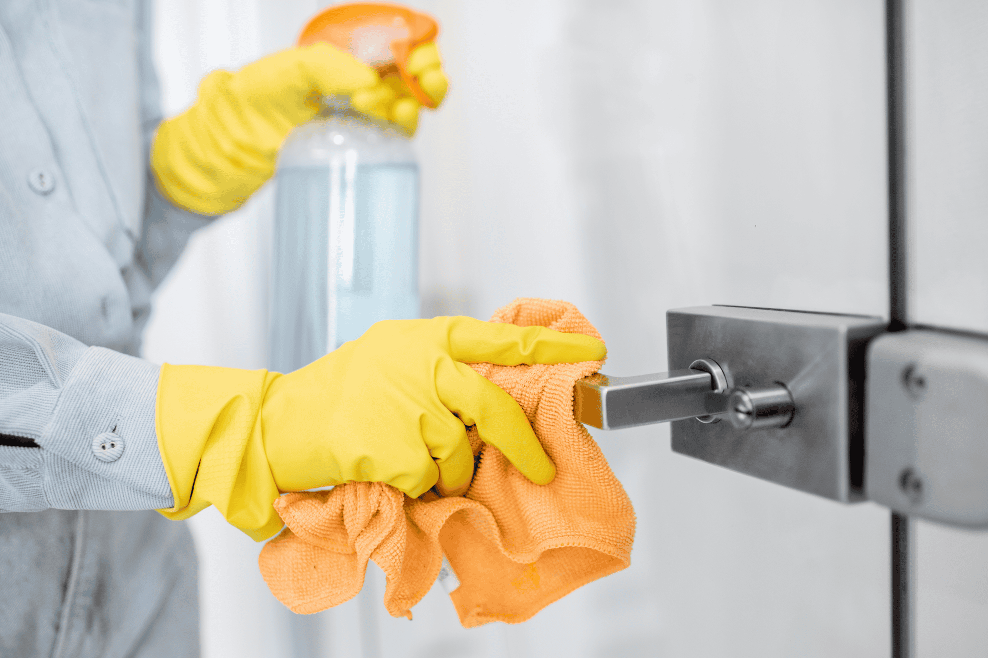 A person cleaning the door handle