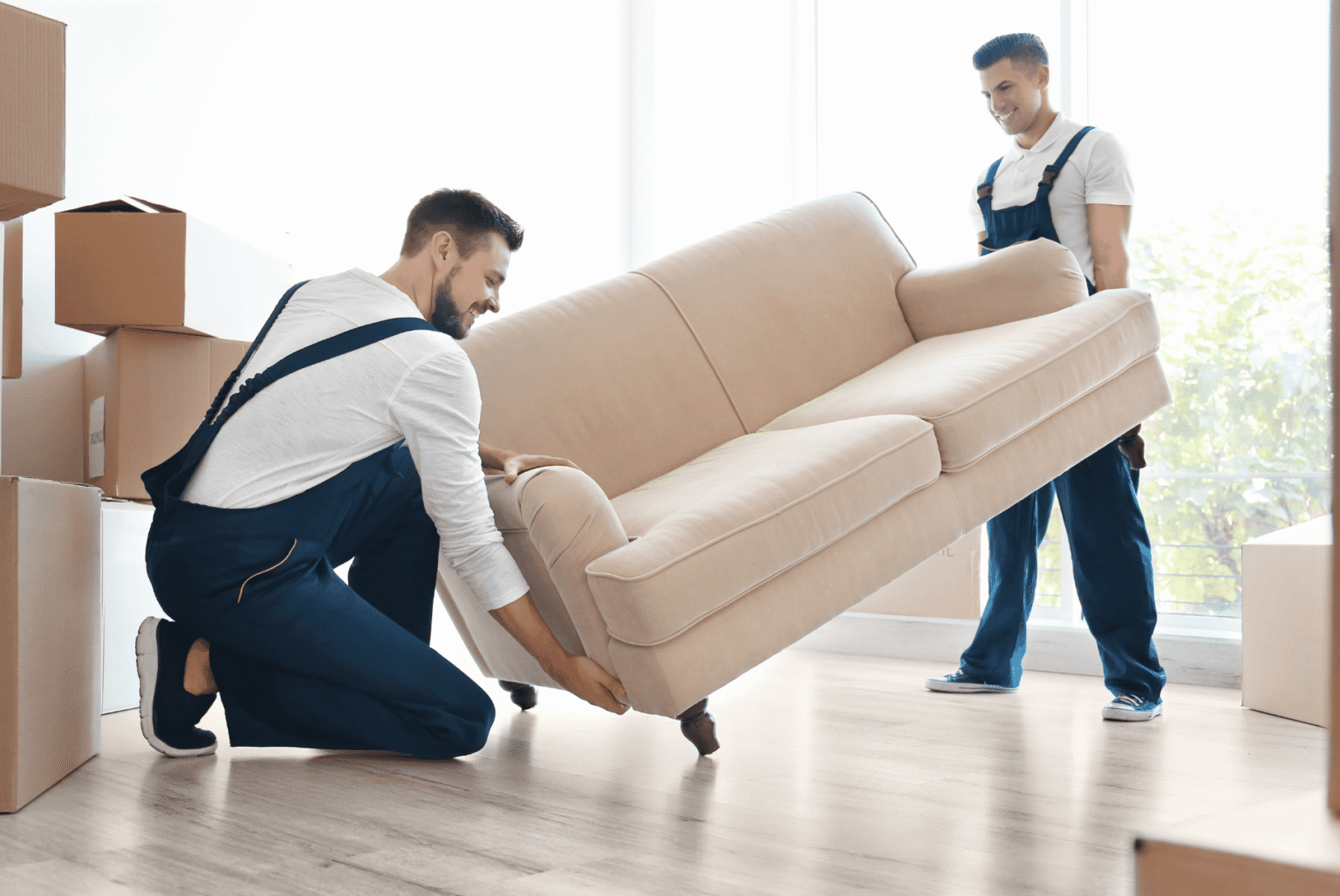 two persons moving a sofa