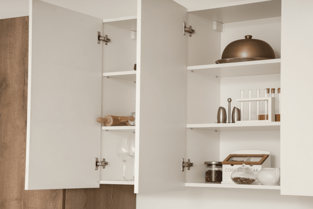 A kitchen with white cabinets and wooden countertops.