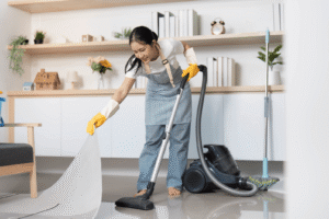 A person vacuuming a room with a vacuum cleaner.