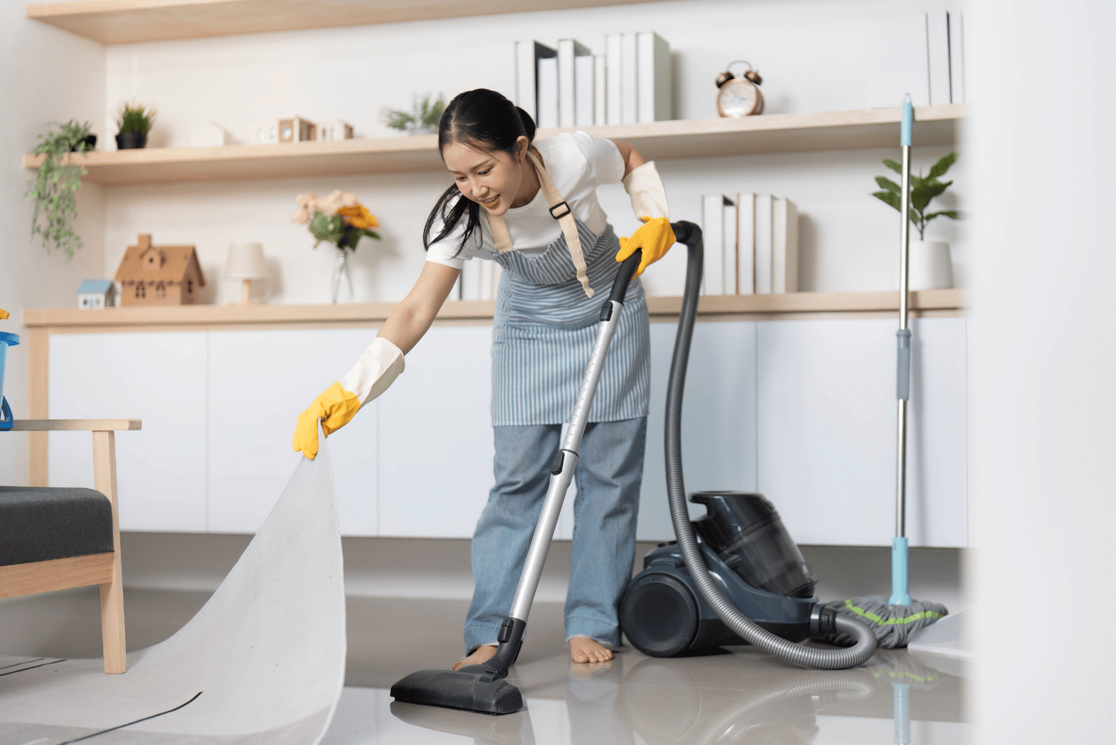 A person vacuuming a room with a vacuum cleaner.